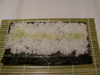 1/2 cup of rice spread on nori with wasabi