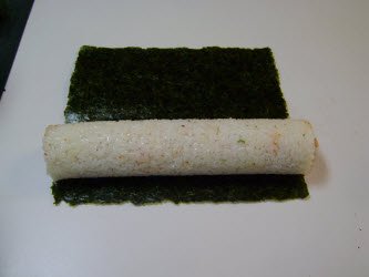 Full sushi roll laying on the nori sheet